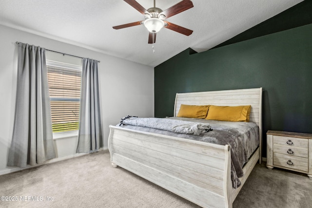 carpeted bedroom with a textured ceiling, lofted ceiling, and ceiling fan