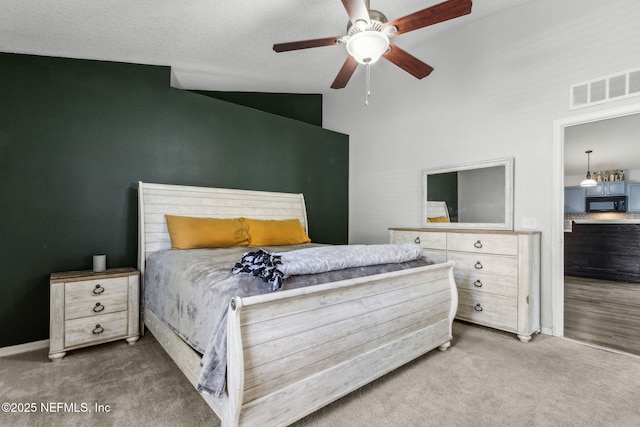 carpeted bedroom with lofted ceiling, ceiling fan, and visible vents