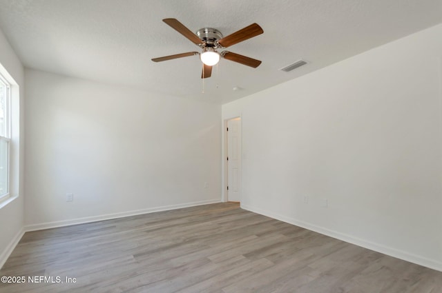 5755 Teeler Ave, Jacksonville, FL 32208 - empty room featuring ceiling fan, wood finished floors, baseboards, and a textured ceiling