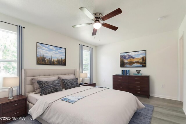5755 Teeler Ave, Jacksonville, FL 32208 - bedroom with light wood finished floors, baseboards, and ceiling fan