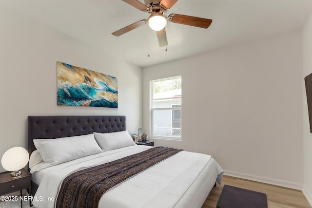 5755 Teeler Ave, Jacksonville, FL 32208 - bedroom with wood finished floors, baseboards, and a ceiling fan