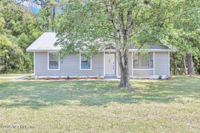 single story home featuring a front lawn