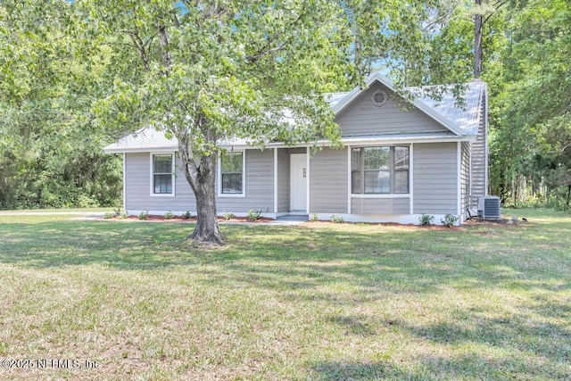 view of front of house featuring central AC unit and a front lawn