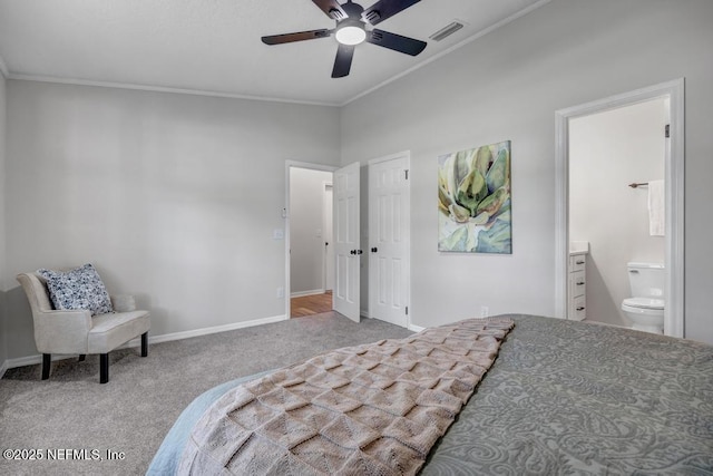 carpeted bedroom featuring crown molding, visible vents, baseboards, and ensuite bathroom