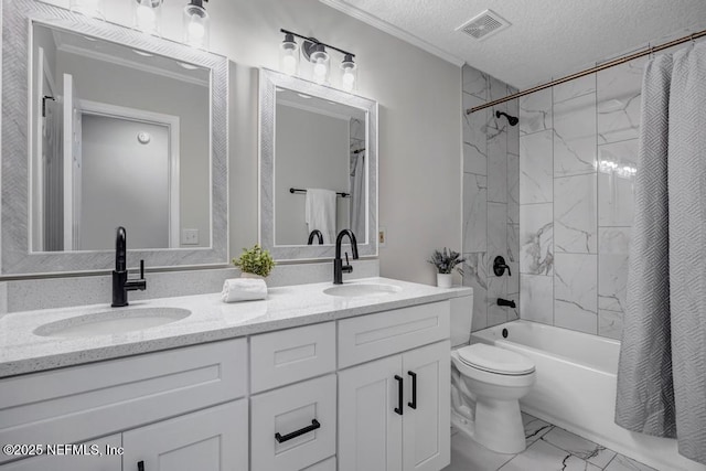full bathroom with shower / bath combo with shower curtain, marble finish floor, a sink, and a textured ceiling