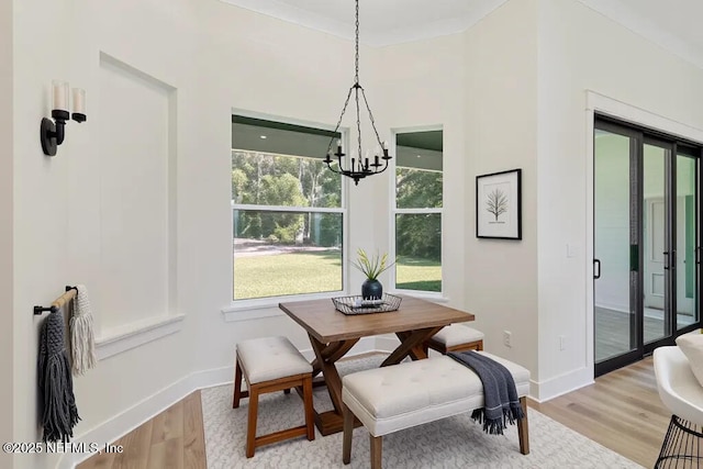 9921 Derby Gate Ct, Jacksonville, FL 32219 - dining room with a chandelier, light wood-style flooring, and baseboards