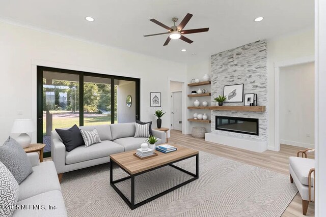 9921 Derby Gate Ct, Jacksonville, FL 32219 - living area featuring light wood-style flooring, recessed lighting, a ceiling fan, built in shelves, and a large fireplace