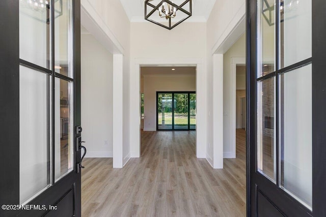 9921 Derby Gate Ct, Jacksonville, FL 32219 - foyer with a chandelier, light wood finished floors, and baseboards