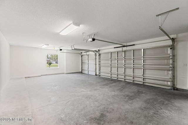 9921 Derby Gate Ct, Jacksonville, FL 32219 - garage featuring a garage door opener and baseboards