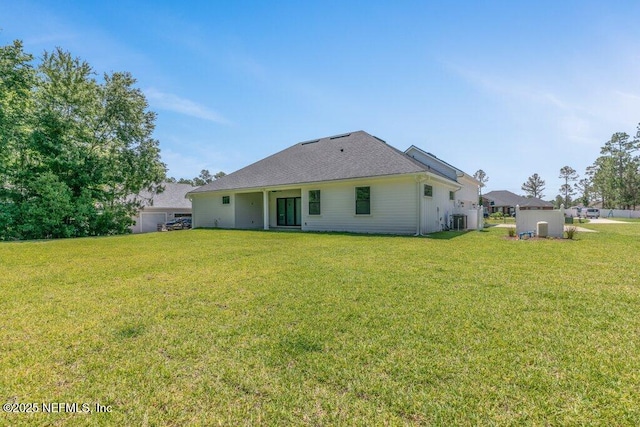 9921 Derby Gate Ct, Jacksonville, FL 32219 - back of house featuring central AC and a yard