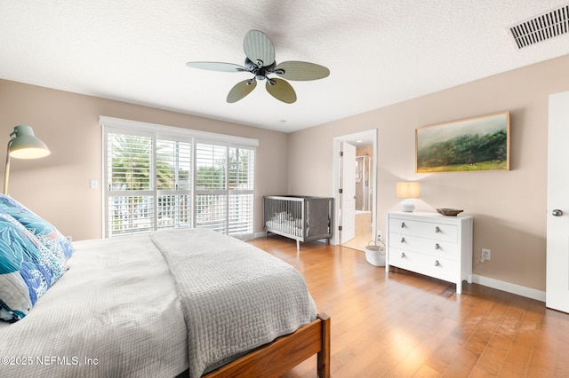 424 High Tide Dr, Saint Augustine, FL 32080 - bedroom with visible vents, baseboards, a ceiling fan, a textured ceiling, and wood finished floors