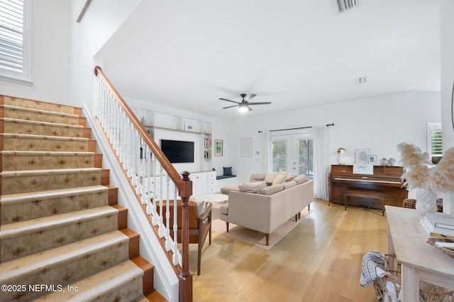 424 High Tide Dr, Saint Augustine, FL 32080 - living area with visible vents, ceiling fan, stairway, light wood finished floors, and french doors