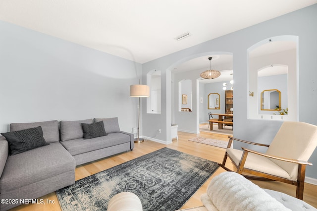 424 High Tide Dr, Saint Augustine, FL 32080 - living area featuring visible vents, baseboards, arched walkways, and wood finished floors
