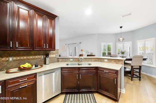 424 High Tide Dr, Saint Augustine, FL 32080 - kitchen with visible vents, a sink, a peninsula, stainless steel dishwasher, and decorative backsplash