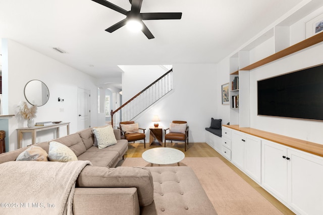 424 High Tide Dr, Saint Augustine, FL 32080 - living room featuring light wood-type flooring, ceiling fan, visible vents, and stairs