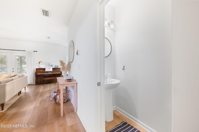 424 High Tide Dr, Saint Augustine, FL 32080 - bathroom featuring french doors, wood finished floors, baseboards, and visible vents