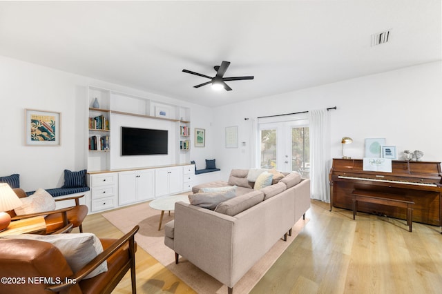 424 High Tide Dr, Saint Augustine, FL 32080 - living room with french doors, ceiling fan, visible vents, and light wood-style flooring
