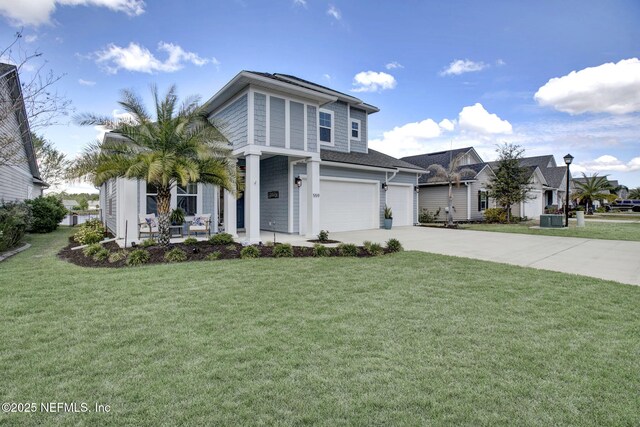 559 Willow Lake Dr, Saint Augustine, FL 32092 - view of front of home with driveway, a garage, a front lawn, a porch, and central AC