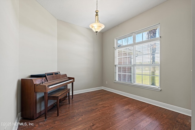 living area featuring dark wood finished floors and baseboards