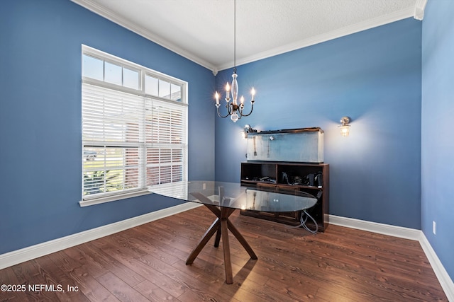 dining room with baseboards, a notable chandelier, wood finished floors, and ornamental molding