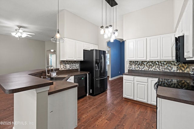kitchen with a sink, dark countertops, dishwasher, a ceiling fan, and fridge with ice dispenser