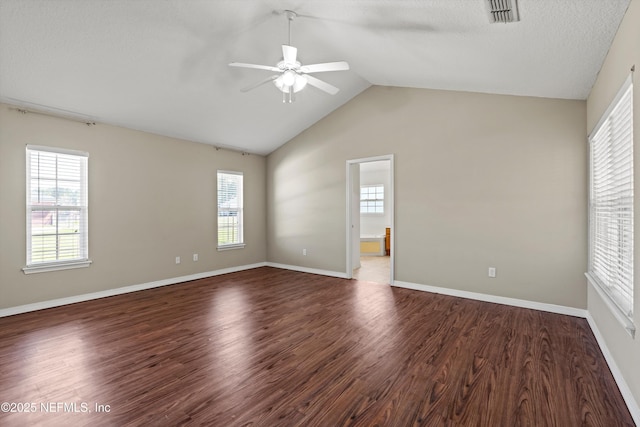 unfurnished room with visible vents, lofted ceiling, wood finished floors, and ceiling fan