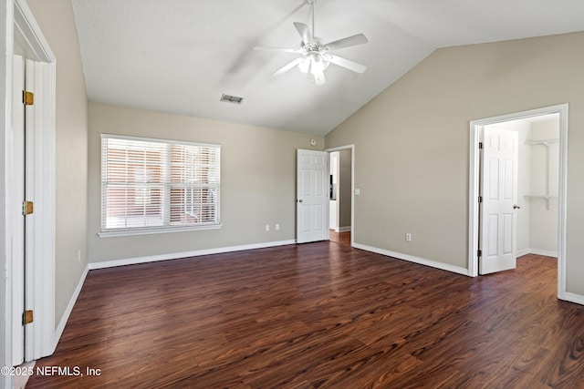 unfurnished bedroom featuring visible vents, baseboards, lofted ceiling, and dark wood finished floors