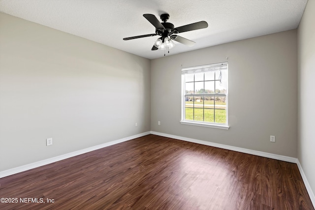 spare room featuring baseboards, a textured ceiling, dark wood-style floors, and ceiling fan