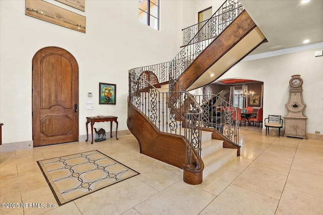 57 Ponte Vedra Blvd, Ponte Vedra Beach, FL 32082 - foyer featuring arched walkways, stairway, ornamental molding, a high ceiling, and a chandelier