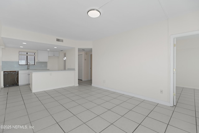 731 1st St S Unit 418, Jacksonville Beach, FL 32250 - unfurnished living room featuring baseboards, visible vents, a sink, and light tile patterned floors