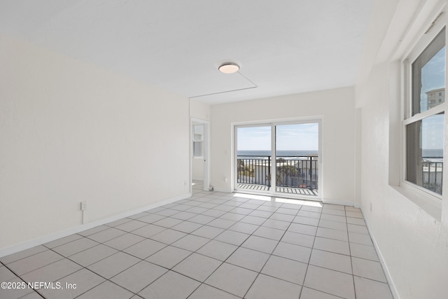 731 1st St S Unit 418, Jacksonville Beach, FL 32250 - unfurnished room featuring light tile patterned flooring, a water view, and baseboards