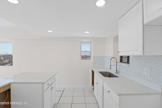 731 1st St S Unit 418, Jacksonville Beach, FL 32250 - kitchen featuring white cabinetry, tasteful backsplash, recessed lighting, light tile patterned floors, and a sink