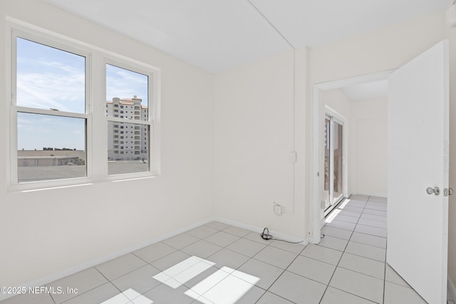 731 1st St S Unit 418, Jacksonville Beach, FL 32250 - unfurnished room with baseboards and light tile patterned floors