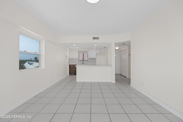 731 1st St S Unit 418, Jacksonville Beach, FL 32250 - unfurnished living room with light tile patterned flooring, baseboards, and visible vents