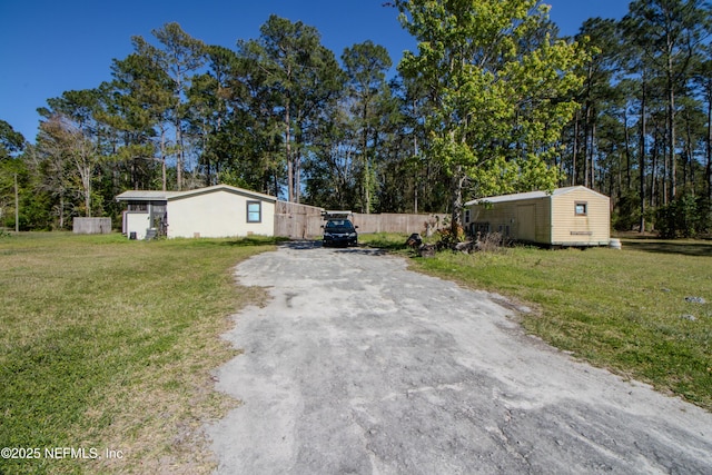 123 Old Airport Estates Rd, Palatka, FL 32177 - exterior space with driveway, a front yard, an outdoor structure, and fence