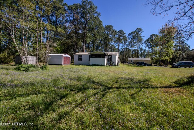 123 Old Airport Estates Rd, Palatka, FL 32177 - view of yard featuring an outbuilding, fence, and a storage shed