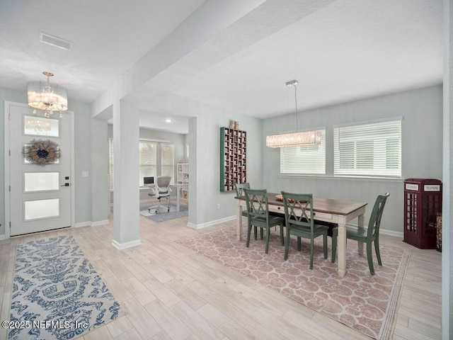 812 Windley Dr, Saint Augustine, FL 32092 - dining space featuring light wood finished floors, baseboards, visible vents, and a chandelier