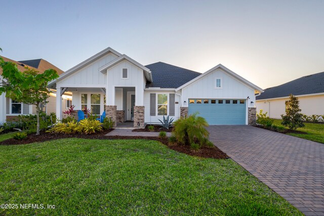 812 Windley Dr, Saint Augustine, FL 32092 - view of front facade with an attached garage, a front yard, board and batten siding, and decorative driveway