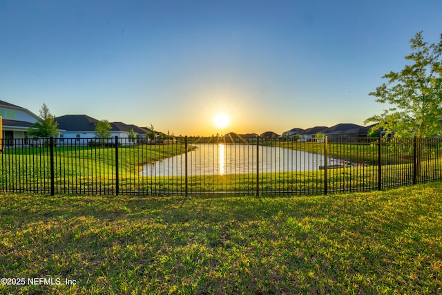 812 Windley Dr, Saint Augustine, FL 32092 - yard at dusk featuring fence, a water view, and a residential view