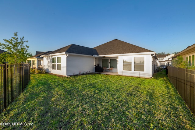 812 Windley Dr, Saint Augustine, FL 32092 - rear view of property featuring a patio, a lawn, a shingled roof, and a fenced backyard