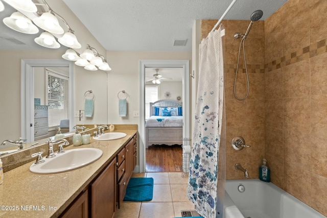bathroom with ensuite bathroom, visible vents, shower / tub combo with curtain, and a sink