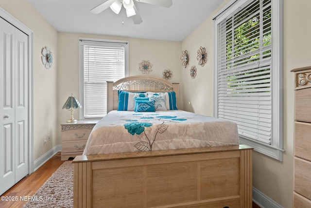 bedroom with a ceiling fan, baseboards, and wood finished floors