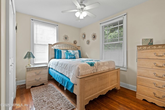 bedroom with dark wood-type flooring, baseboards, and a ceiling fan
