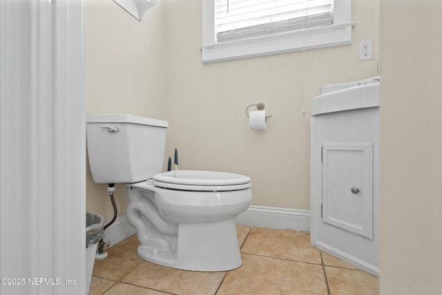 bathroom with tile patterned floors, toilet, and baseboards