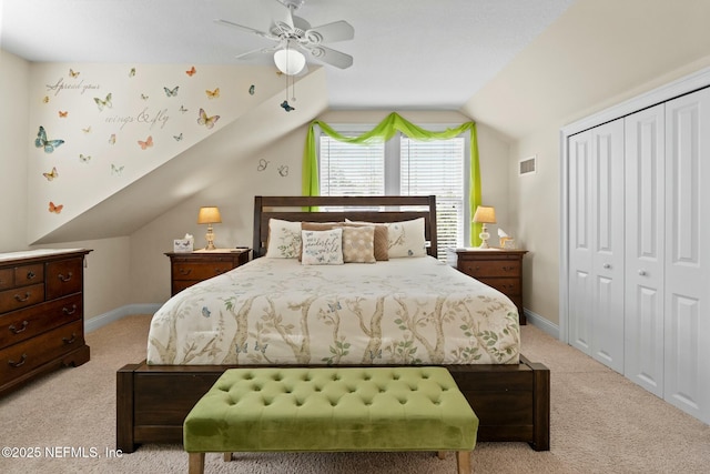 bedroom with visible vents, a closet, carpet, and vaulted ceiling