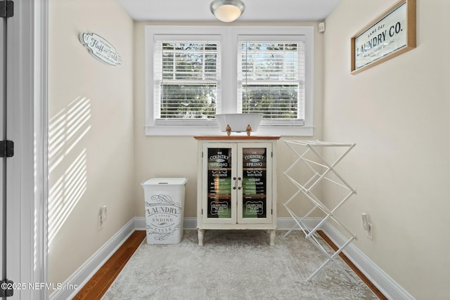 interior space featuring baseboards and wood finished floors