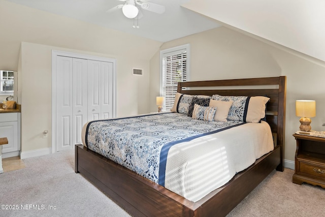 bedroom featuring lofted ceiling, carpet, ceiling fan, visible vents, and a closet