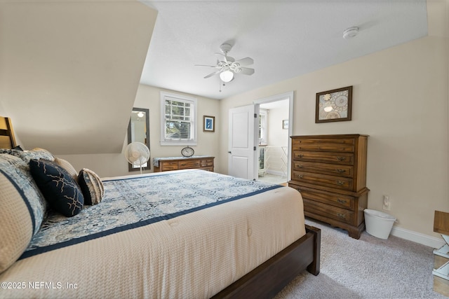 carpeted bedroom featuring baseboards, ensuite bath, and a ceiling fan