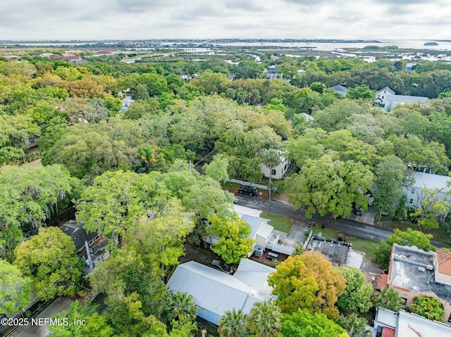 birds eye view of property featuring a wooded view