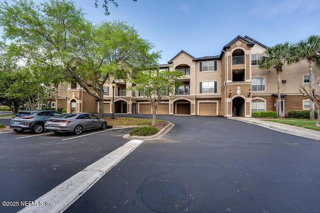 10961 Burnt Mill Rd Unit 321, Jacksonville, FL 32256 - townhome / multi-family property featuring a garage and stucco siding